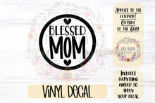 Load image into Gallery viewer, &quot;Blessed Mom&quot; inside of a circle with two hearts, one below and one above the wording.   Adhesive vinyl window decal - sticks the glass window or windshield of your automobile (Car, Truck, SUV, Crossover, Van, Minivan).  An alternative to bumper stickers and window clings.  Makes the perfect automotive accessory for the Proud Mom or to give as a gift fro the Best Mom on any occasion.  Applies to the exterior / outside of your window.  Includes everything you need to apply your decal.
