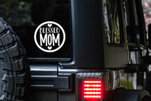 Load image into Gallery viewer, &quot;Blessed Mom&quot; inside of a circle with two hearts, one below and one above the wording.   Adhesive vinyl window decal - sticks the glass window or windshield of your automobile (Car, Truck, SUV, Crossover, Van, Minivan).  An alternative to bumper stickers and window clings.  Makes the perfect automotive accessory for the Proud Mom or to give as a gift fro the Best Mom on any occasion.
